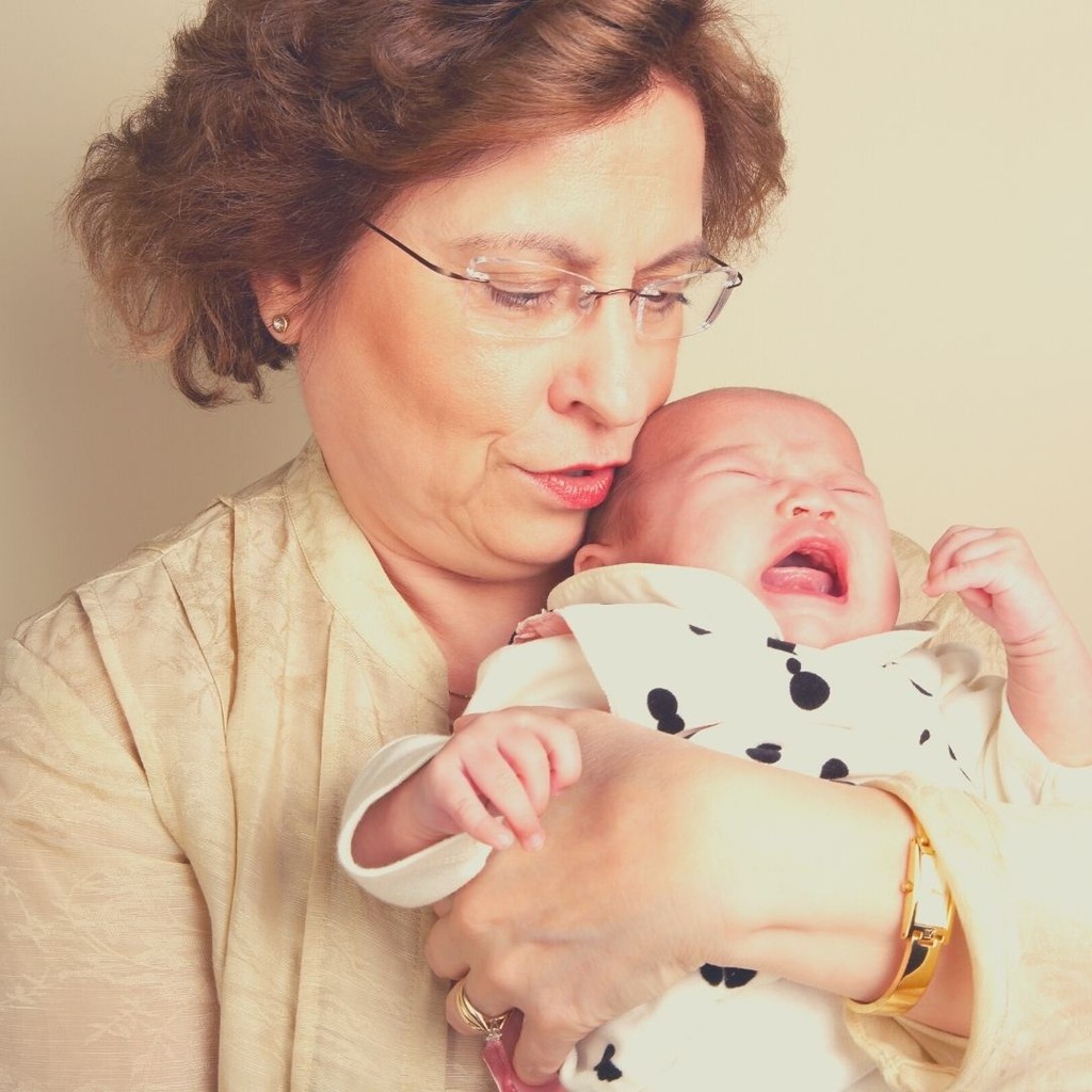 picture of grandmother holding crying baby
