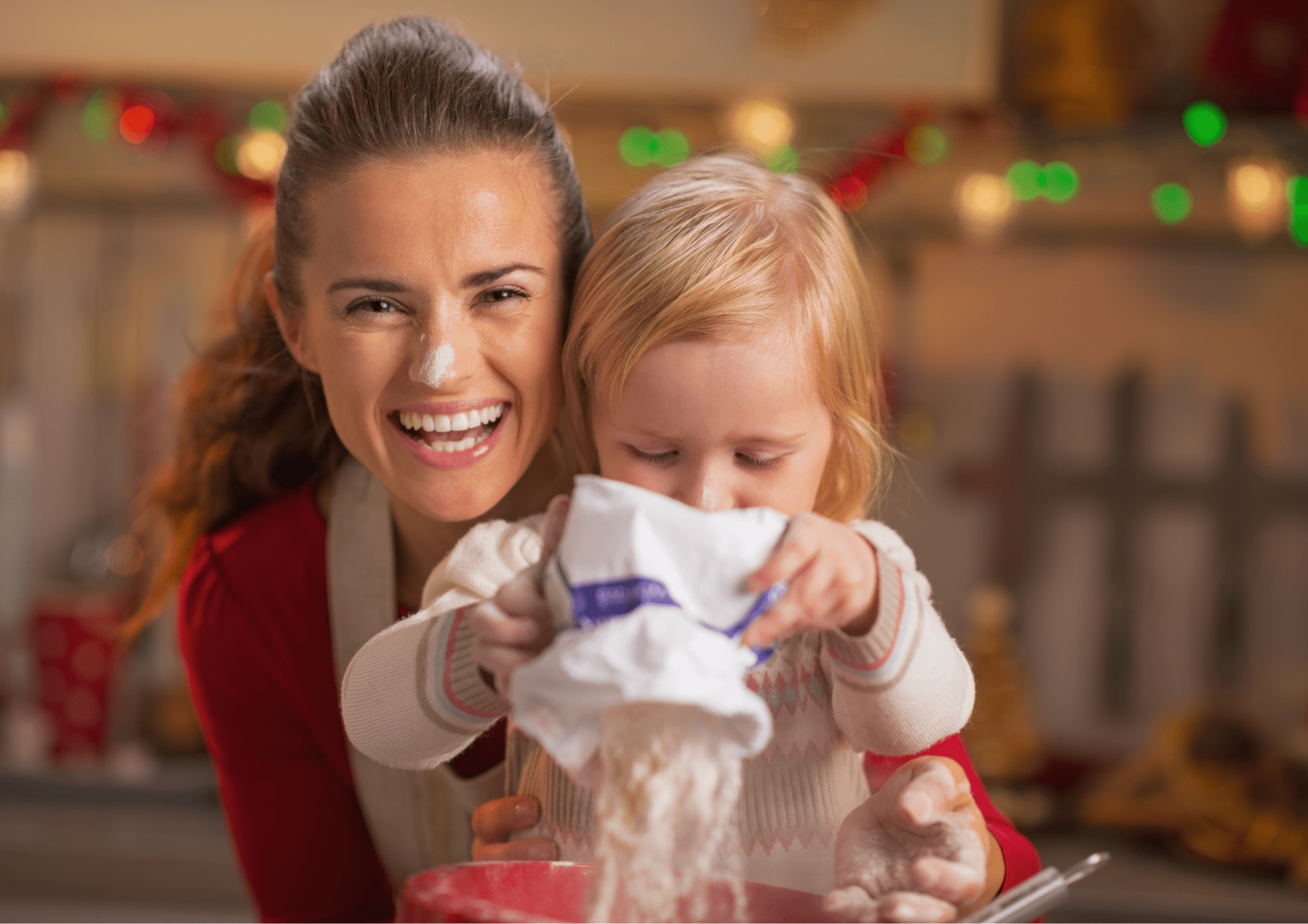 photo of a happy mother baking at home with her toddler